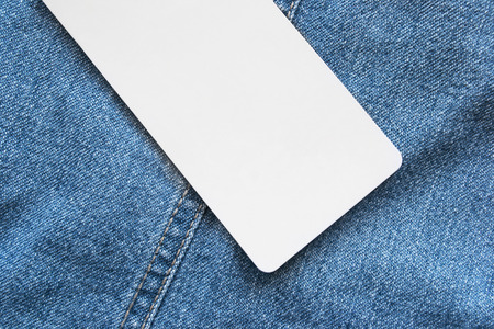 Blank white label on blue denim as a backgroundの写真素材
