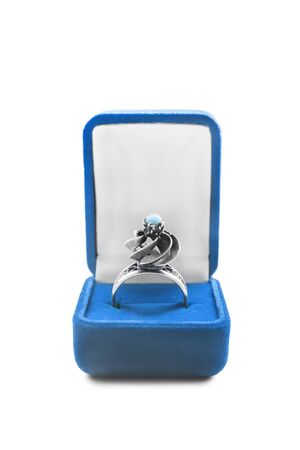 Silver turquoise ring in blue box on white backgroundの写真素材