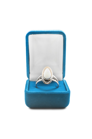 Beautiful nacre ring in blue box isolated over whiteの写真素材
