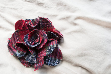 Floral brooch on beige linen as a background