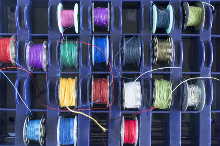 Set of spools with colorful threads as a backgroundの写真素材