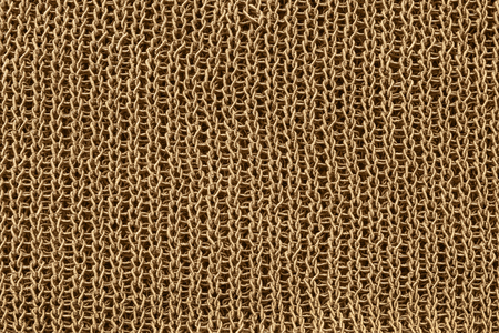 Golden knitted texture closeup as a backgroundの写真素材