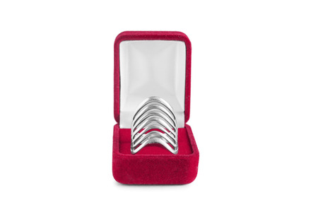 Silver ring in red jewel box isolated over whiteの写真素材