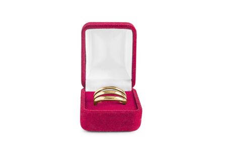 Golden ring in red jewel box isolated over whiteの写真素材