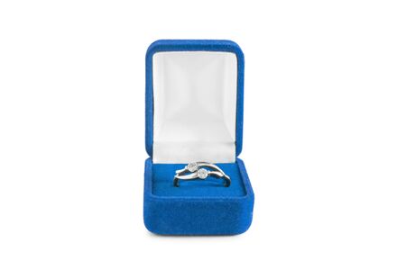 Silver diamond ring in blue box isolated over whiteの写真素材