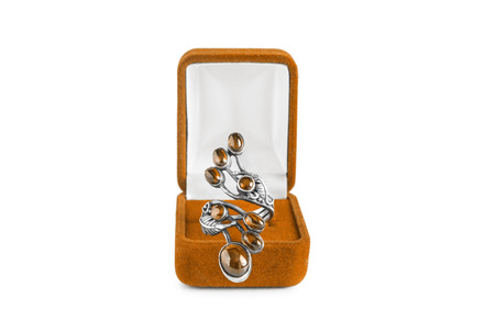Beautiful amber ring in jewel box isolated over whiteの写真素材