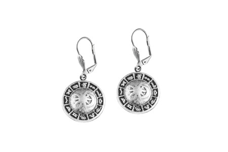 Silver zodiac earrings on white backgroundの写真素材