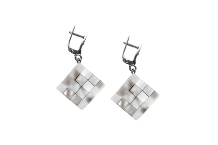 Nacre chess earrings on white backgroundの写真素材