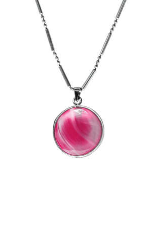 Pink glass medallion on a chain isolated over whiteの写真素材