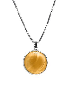 Amber medallion on a chain isolated over whiteの写真素材