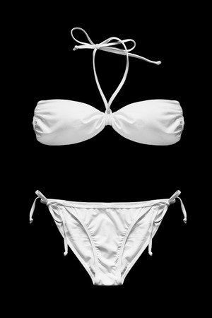 White bikini with laces isolated over blackの写真素材