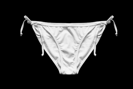 White bikini bottom with laces isolated over blackの写真素材