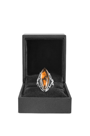 Vintage amber ring in black box on white backgroundの写真素材