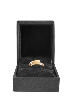 Golden ring in black jewel box on white backgroundの写真素材