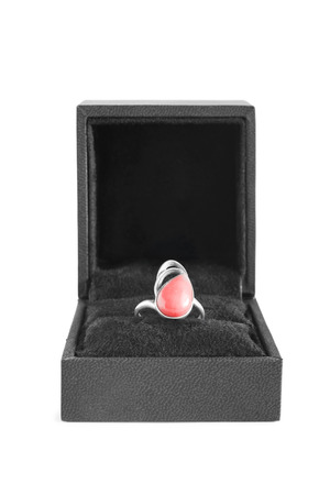 Pink coral ring in black box on white backgroundの写真素材