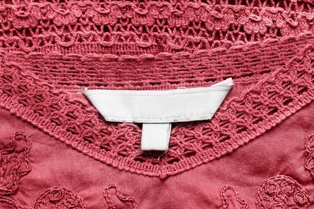 White blank label on red lacy cloth as a backgroundの写真素材