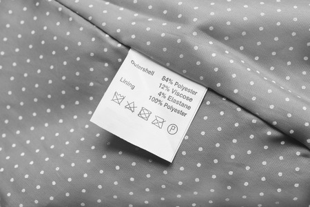 Fabric composition label on gray cloth as a backgroundの写真素材