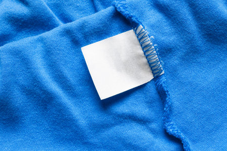 Blank white label on blue cloth as a backgroundの写真素材