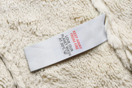 Washing instructions label on synthetic fur as a background