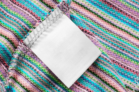 Blank clothes label on knitted cloth as a backgroundの写真素材