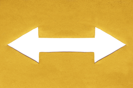Blank white dual arrow in yellow paper as a backgroundの写真素材