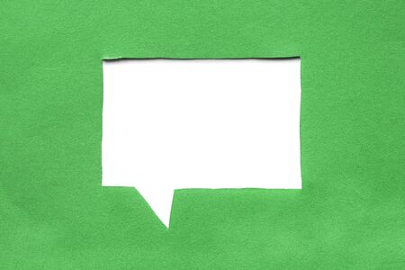 Blank white speech bubble cut in green paperの写真素材