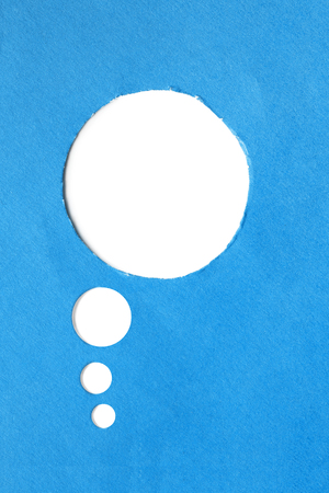 Blank white speech bubble cut in blue paperの写真素材