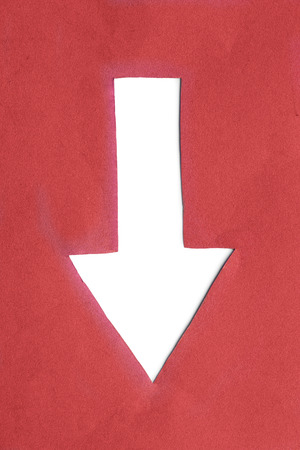 Blank white down arrow cut in red paperの写真素材