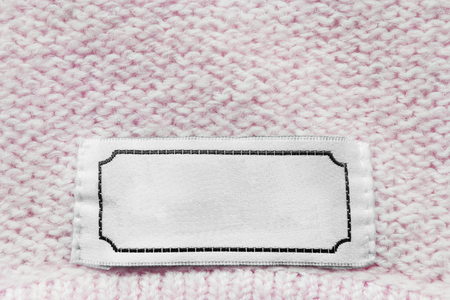 Blank white clothes label on pink wool knittingの写真素材