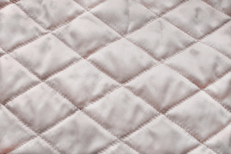 Quilted blush satin texture as a backgroundの写真素材