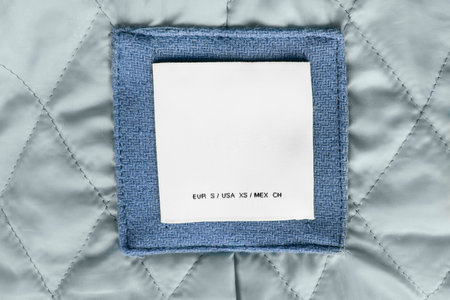 Blank white clothes label on quilted cloth
