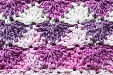 Pink shades knitted ornament as a backgroundの写真素材