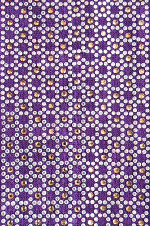 A lot of crystals on purple cloth as a background