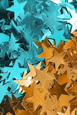 Blue and golden confetti stars as a backgroundの写真素材