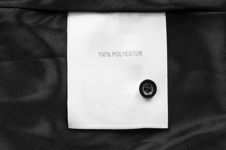 Fabric composition label on black satin as a backgroundの写真素材