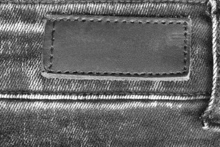Blank leather label on black jeans as a backgroundの写真素材