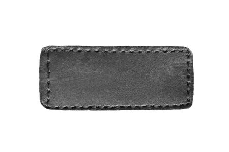 Blank black leather clothes label isolated over whiteの写真素材