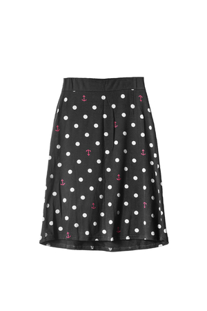 Black knee length skirt with polka dots on white backgroundの写真素材