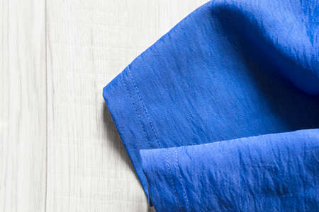 Folded blue silk on white wooden backgroundの写真素材