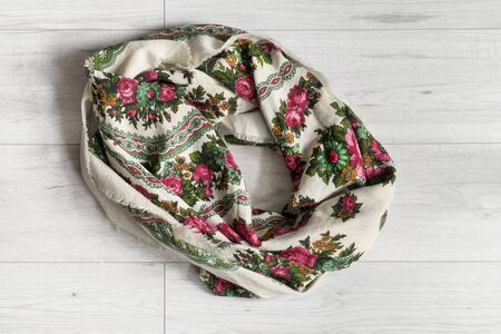 Colorful wool headscarf on white wooden backgroundの写真素材