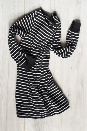 Black and white crumpled dress on white wooden backgroundの写真素材