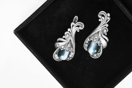 Vintage silver earrings in black jewel box closeup as a backgroundの写真素材