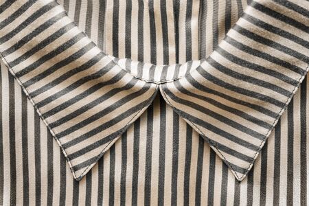 Striped satin blouse collar closeup as a backgroundの写真素材