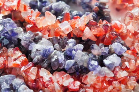 Pieces of amber and amethyst closeup as a backgroundの写真素材