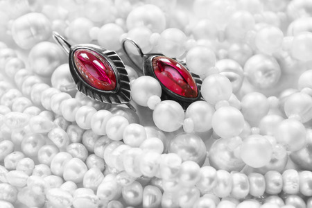 Vintage ruby earrings on white pearl as a backgroundの写真素材