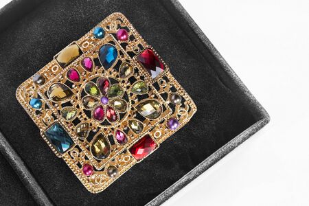 Vintage golden brooch in black jewel box as a backgroundの写真素材