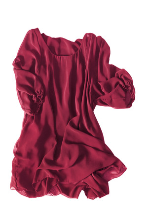 Red silk dress folded on white backgroundの写真素材