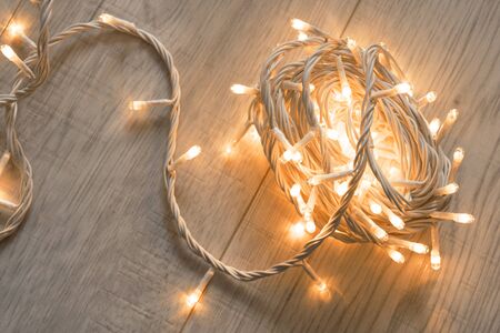 Yellow flash lights on wooden floor as a backgroundの写真素材
