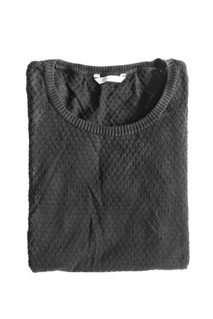 Folded black basic pullover isolated over whiteの写真素材
