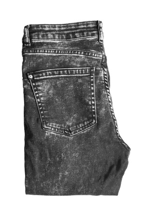 Black folded jeans on white backgroundの写真素材